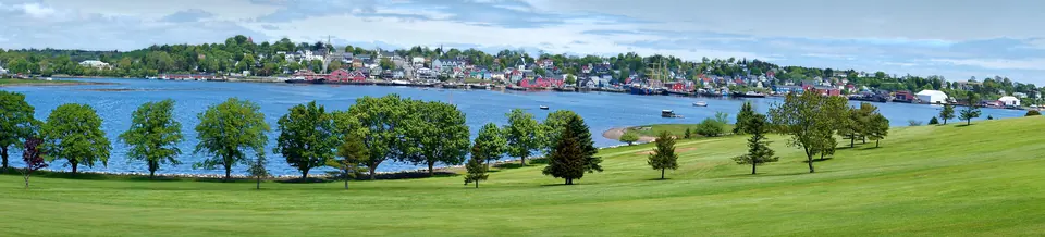 The painted grid of the Old Town seen from the golf-course hill across the harbor