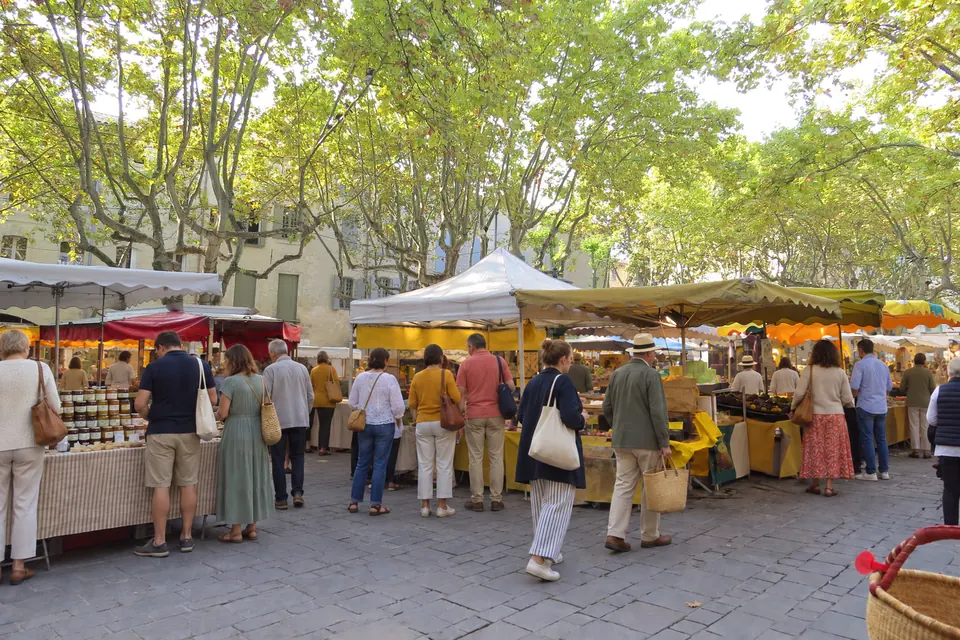 The arcaded Place aux Herbes on market day