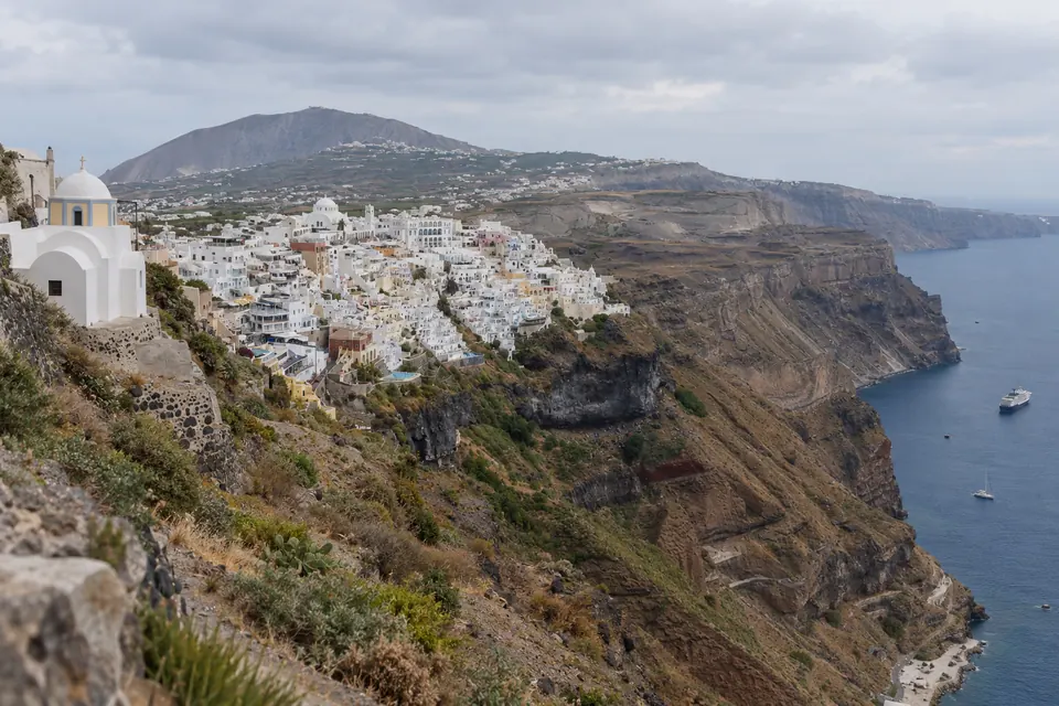 Fira poured down the caldera rim