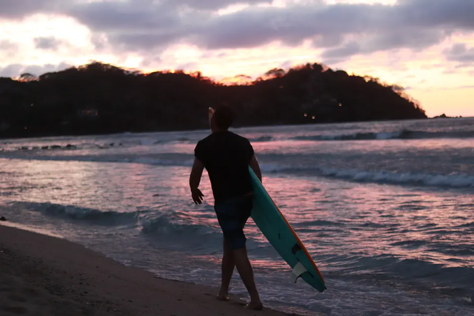 A surfer at dusk