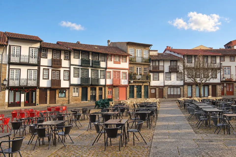 The leaning medieval houses and café terraces