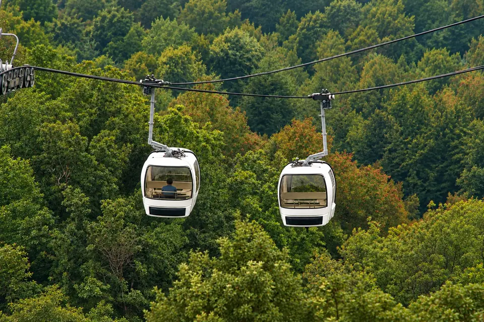 The cable car climbing the wooded slopes of the Penha