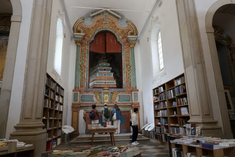 Bookshop shelves rising inside a former church