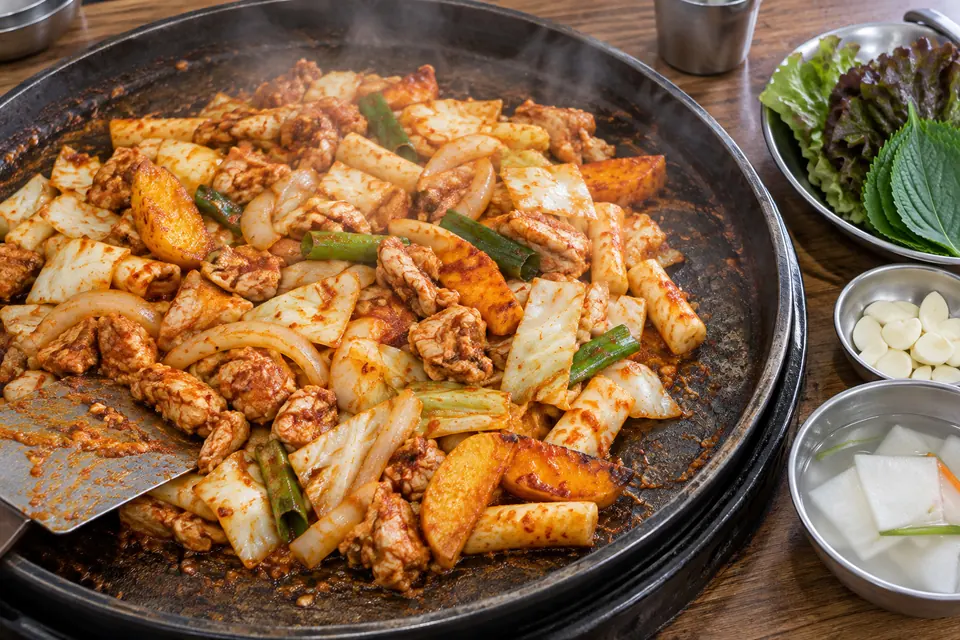 Dakgalbi sizzling on the iron plate in Myeong-dong's alley