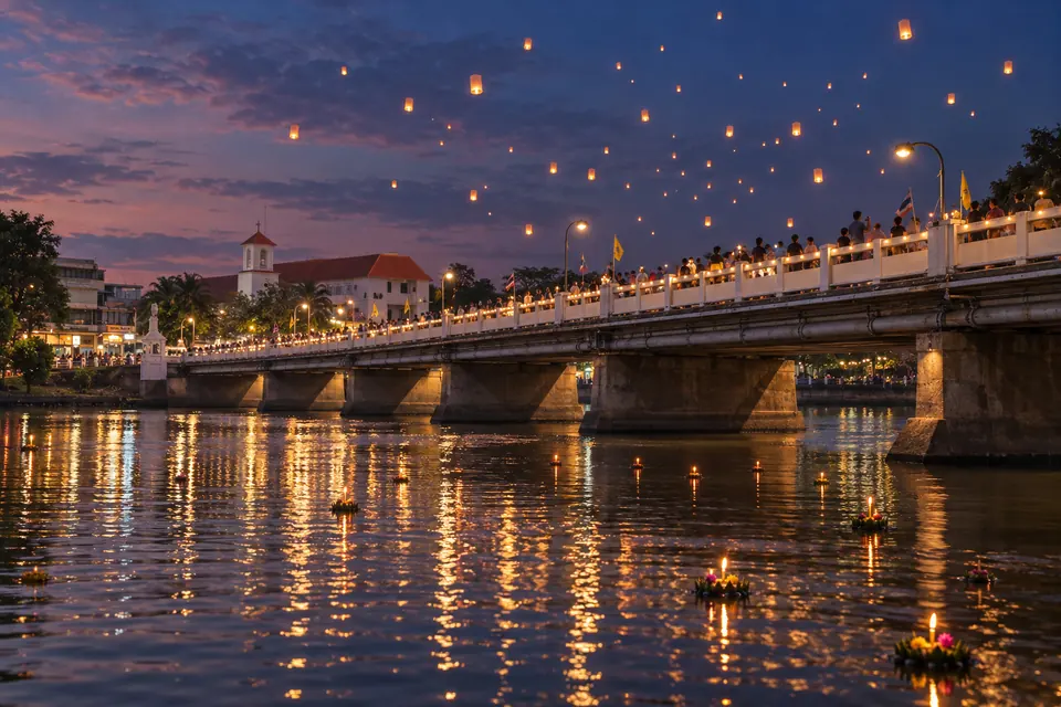 Yi Peng lanterns rising over the city