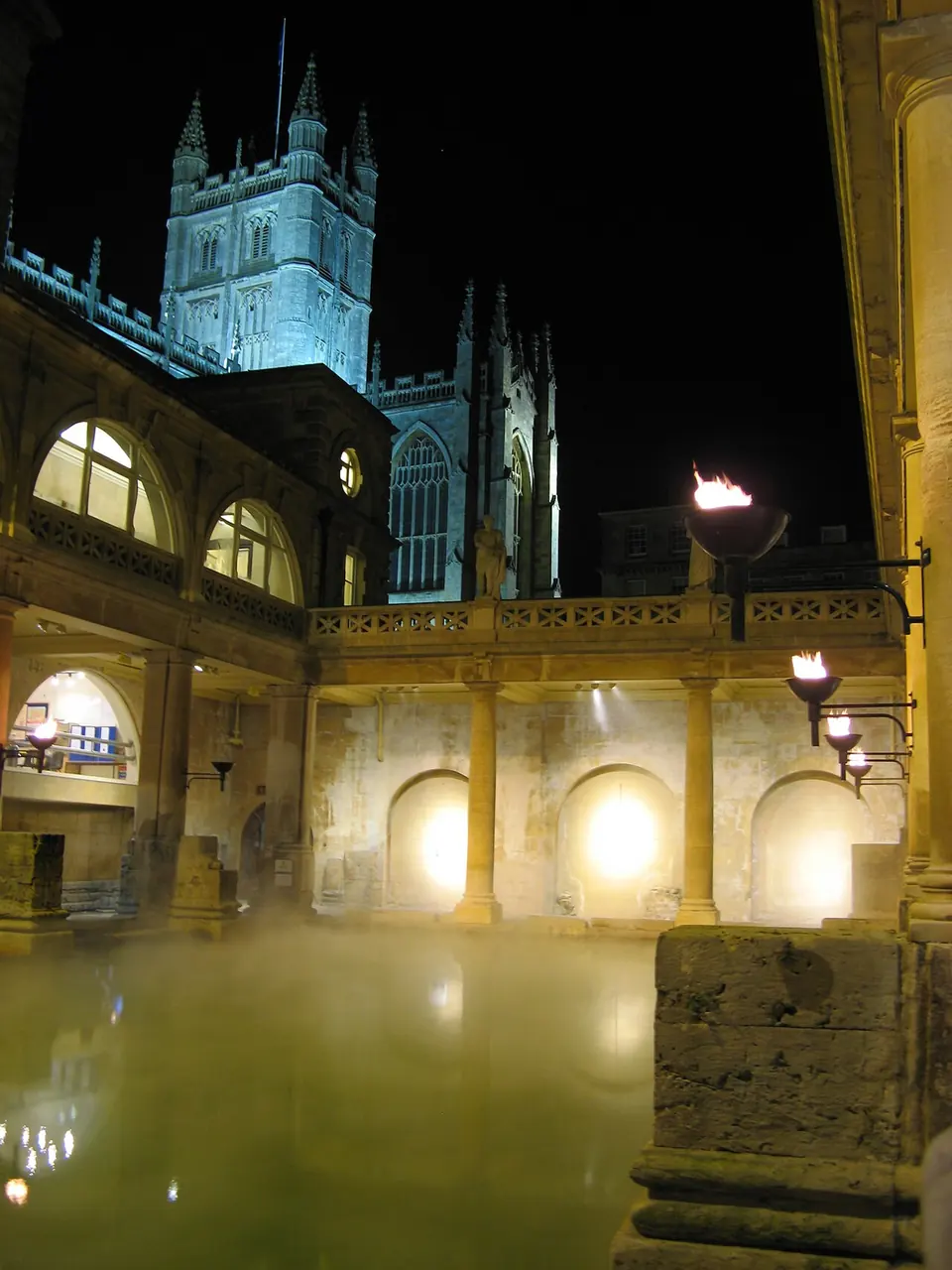 The Great Bath of the Roman Baths with the Abbey tower behind